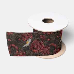 Roodstart in de chrysanten in bruin en rood lint