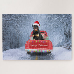 Rottweiler-hond in de sneeuw zittend in Kersttruck Legpuzzel