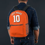 Sac À Dos Imprimé Custom Orange White Nom Sports Jersey Numéro<br><div class="desc">Sac à dos jersey sport conçu sur mesure en orange vif avec lettrage blanc frappant et ombre noire en gras pour votre nom de famille et le numéro choisi. Ce sac à dos personnalisé est un incontournable pour les amateurs de sport, ajoutant une touche d'individualité à votre collection d'équipement. Conçu...</div>