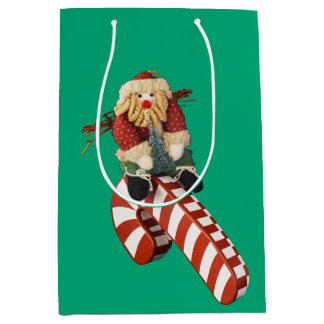 Sac Cadeau Moyen Le Père Noël joue sur un toboggan en canne à sucre