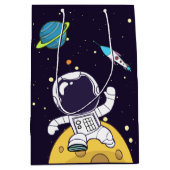 Sac Cadeau Moyen Un astronaute flotte dans l'espace (Devant)
