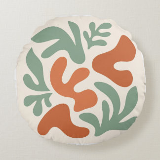 salie groene en terracotta abstracte wandkunst rond kussen