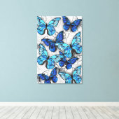 Samenstelling van witte en blauwe vlinders canvas afdruk (Insitu (Houten vloer))