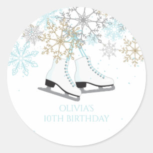 Schaatsende sneeuwvlokken blauw en goud ronde sticker