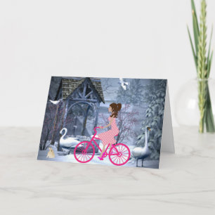 Schattig meisje op een roze fiets winter kaart