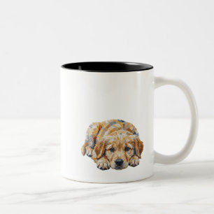 Schattige puppy met treurige ogen die zijn baasje  tweekleurige koffiemok
