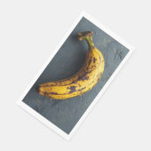 Serviette En Papier Banane exotique posée sur une surface grise (Coin)
