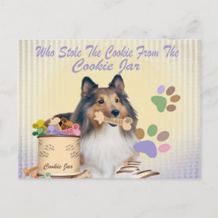 Sheltie houdt het koekje van de kaarten van de koe