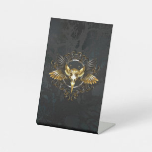 Signe De Table Crâne d'oiseau doré sur fond noir