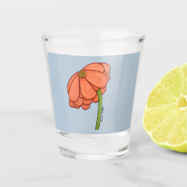 Sinaasappelbloem met blauwe achtergrond shot glas