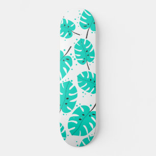 Skateboard met tropische bladeren.