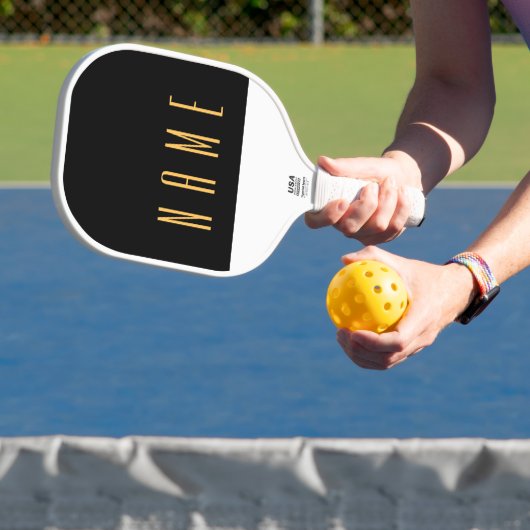 Slanke zwart-wit driekwart kleur blok tekst pickleball paddle (Insitu)