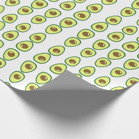 Slicte groene avocado op wit cadeaupapier (Hoek)