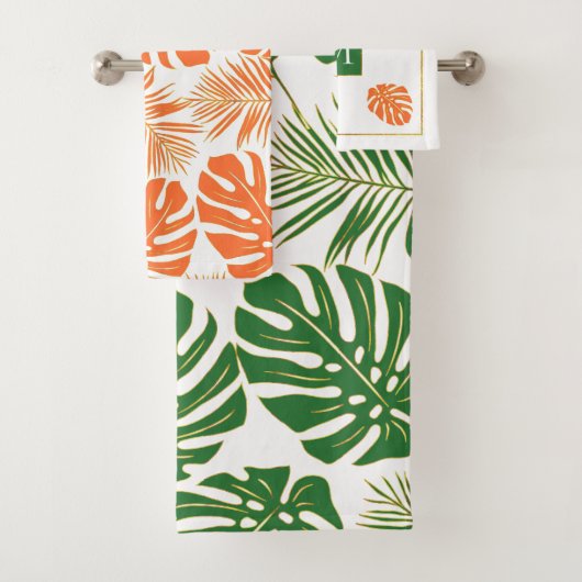 Smaragdgroene, oranje tropische bladeren en monogr bad handdoek (Insitu)