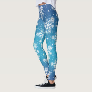 Sneeuwvlokken en sterren op een bleke blauwe gradi leggings