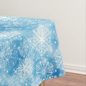 Sneeuwvlokken op blauw tafelkleed (Voorbeeld)