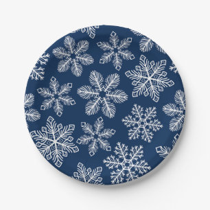 Sneeuwvlokken op donkerblauw papieren bordje