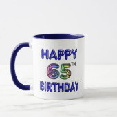 Soixante-cinquième tasse heureuse d'anniversaire (Gauche)