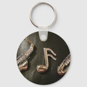 Speel een muzieknotitie over die saxafone sleutelhanger