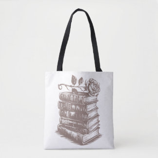 Stapel boeken bekroond met een roos draagtas