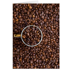 Stapel koffiebonen met koffiekopje vol bonen