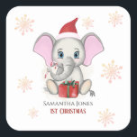 Sticker Carré Baby Girl First Christmas Jote Elephant Holidays<br><div class="desc">Adorable petit éléphant avec un casquette de Noël,  un cadeau de Noël,  tenant un bonbon de canne de Noël et un arrière - plan enneigé avec de beaux flocons de neige. Bébé Fêtes de Noël. Personnalisez en changeant le nom.</div>