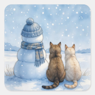 Sticker Carré Chats assis avec un bonhomme de neige dans un cham