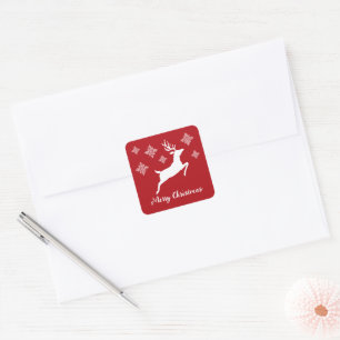 Sticker Carré Forme de cerf blanc sur fond rouge avec flocons de