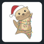 Sticker Carré Otter Christmas Snow Winter Animals<br><div class="desc">The otter at Christmas with fairy lights. Funny animals with toxits and snow for the holidays. Donc Funny for Christmas in July. Otters are cute animals et perfect pour Christmas.</div>