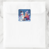 Sticker Carré Petite fille Lire une histoire à un Noël de Snowma (Sac)