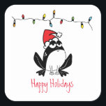 Sticker Carré Whimsical Christmas Frog<br><div class="desc">Illustration de grenouille blanche et noire avec chapeau de Père Noël rouge,  chaîne de lumières de vacances et texte personnalisable "Joyeuses Fêtes"</div>