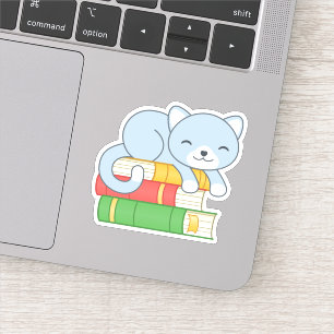 Sticker Chat mignon au-dessus de la pile de livres