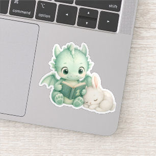 Sticker Joli bébé dragon lisant un livre en aquarelle pour