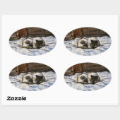 Sticker Ovale Couchage de chat sur un lit (Feuille)