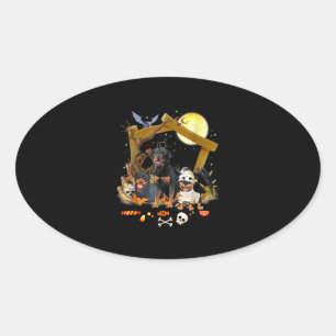 Sticker Ovale Trois chiens de Rottweiler à Halloween