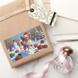 Sticker Rectangulaire Chien Papillon courant dans la neige avec un chape