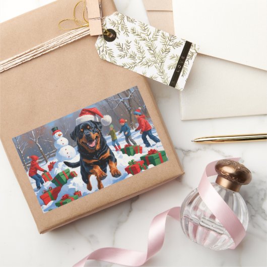 Sticker Rectangulaire Rottweiler coule en neige avec Casquette de Noël (Cadeaux)