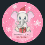 Sticker Rond Baby Girl First Christmas Jote Elephant Holidays<br><div class="desc">Adorable petit éléphant avec un casquette de Noël,  un cadeau de Noël,  tenant un bonbon de canne de Noël et un arrière - plan enneigé avec de beaux flocons de neige. Bébé Fêtes de Noël. Personnalisez en changeant le nom.</div>