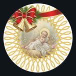 Sticker Rond Baby Jesus Manger Christmas Bells Ribbon<br><div class="desc">Belle image du Bébé Jésus couché dans la crèche. Les cloches de Noël et le ruban accentuent l'image.</div>