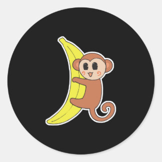 Sticker Rond bébé singe mignon sur une banane