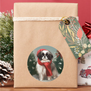 Sticker Rond Chien Japonais Chin dans la neige de Noël