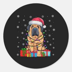 Sticker Rond Chien laide Noël éclaire le chapeau de Noël Tibéta