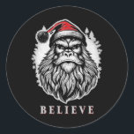 Sticker Rond Christmas Bigfoot - Croire en Bigfoot porter San<br><div class="desc">Christmas Bigfoot - Croyez en Bigfoot portant le chapeau du Père Noël</div>