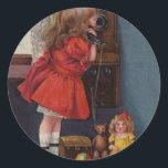 Sticker Rond Christmas Little Girl Téléphone Antique<br><div class="desc">Cette belle image provient d'une ancienne carte de Noël,  montrant une petite fille qui fait son appel téléphonique de Noël. Vintage et ancien.</div>