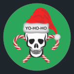 Sticker Rond Christmas, Pirate Skull<br><div class="desc">Pirate skull wearing Santa a eu le Yo-HO-HO. A pair of crossed candy canes are behind the skull.</div>