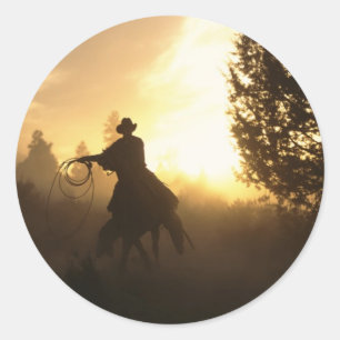 Sticker Rond Cowboy avec Lasso au coucher du soleil