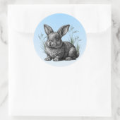 Sticker Rond Cute Grey Rabbit contre un ciel bleu (Sac)