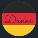 Sticker Rond Drapeau allemand couleurs Danke<br><div class="desc">Danke ... une langue allemande merci message contre les couleurs du drapeau de l'Allemagne. Vous pouvez modifier le style moderne monoline whimsical calligraphy pour créer votre propre message texte personnalisé. Essayez un style de police, une taille et une couleur différentes et personnalisez la conception du texte pour créer vos propres...</div>