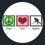 Sticker Rond Hockey sur gazon Peace Love<br><div class="desc">Le signe de paix,  le coeur,  et la silhouette d'un joueur de hockey sur gazon en action.</div>