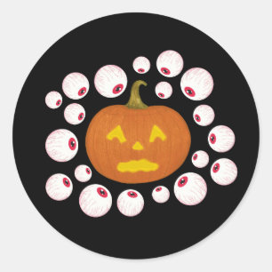 Sticker Rond Jack-o-Lantern Citrouille et les yeux dans l'obscu